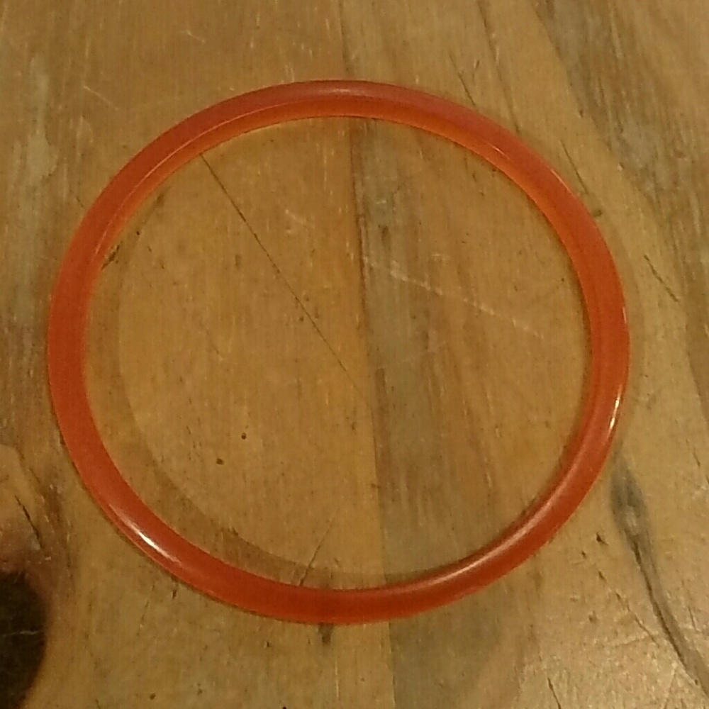 Orange plastic skinny bracelet.